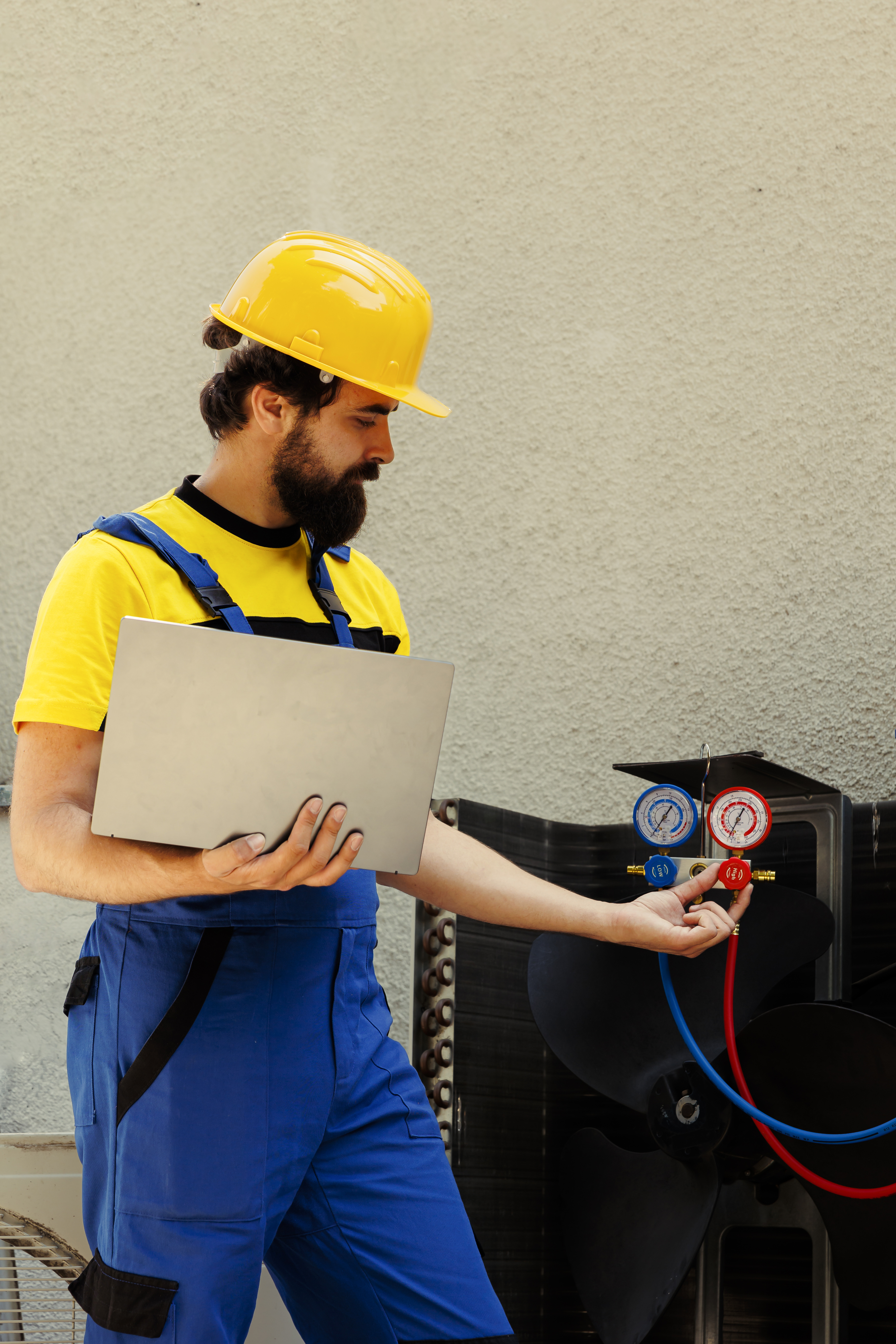 Technician calibrating HVAC pressure device